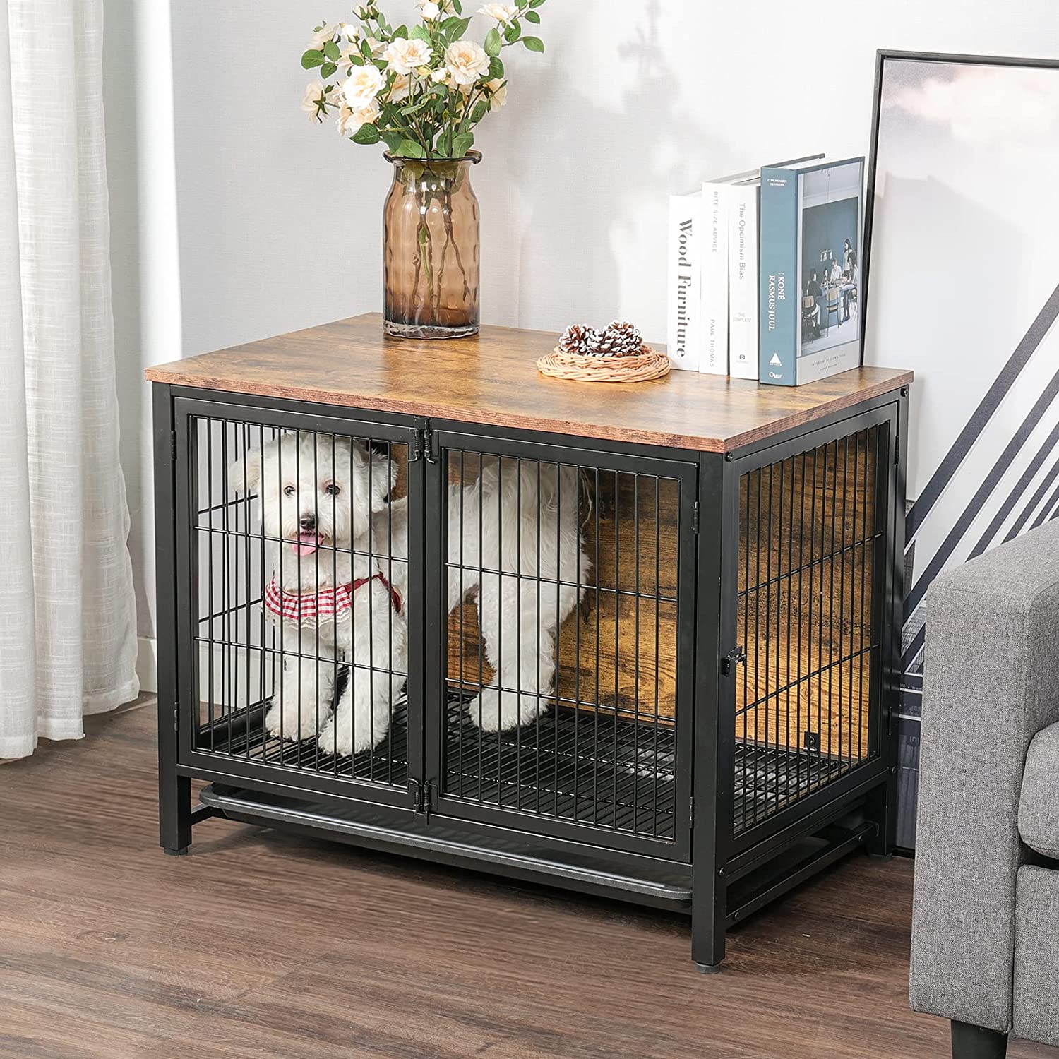 White dog stands in the dog kennel with double doors that near sofa